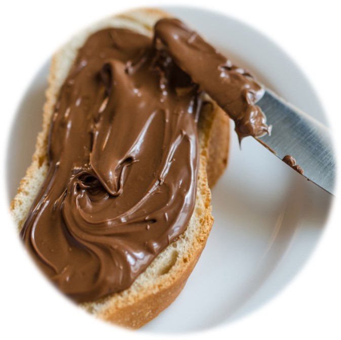 Spread chocolate on a bread using knife.