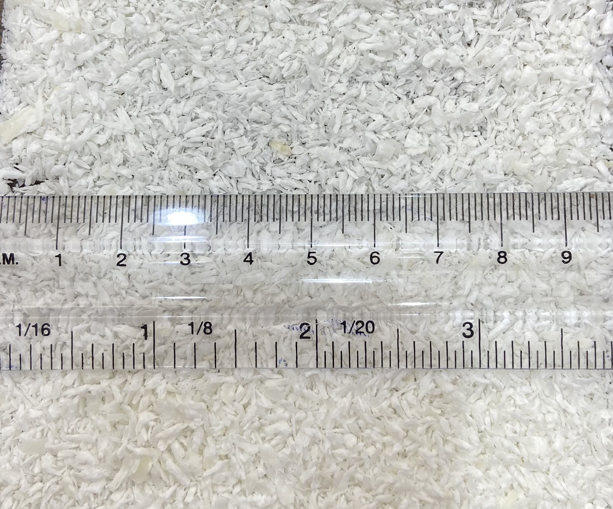 Size of desiccated coconut measured by ruler showing the size in CM.